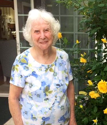 woman next to rose bush
